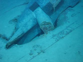 Stbd anchor embedded in steel plate from ship's side in debris field